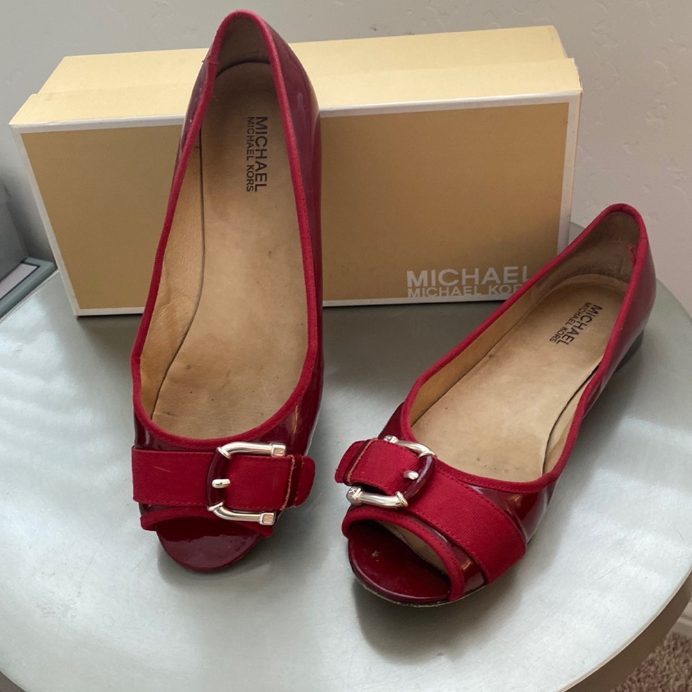 Kate Spade Red patent leather open toe flats with silver buckle.